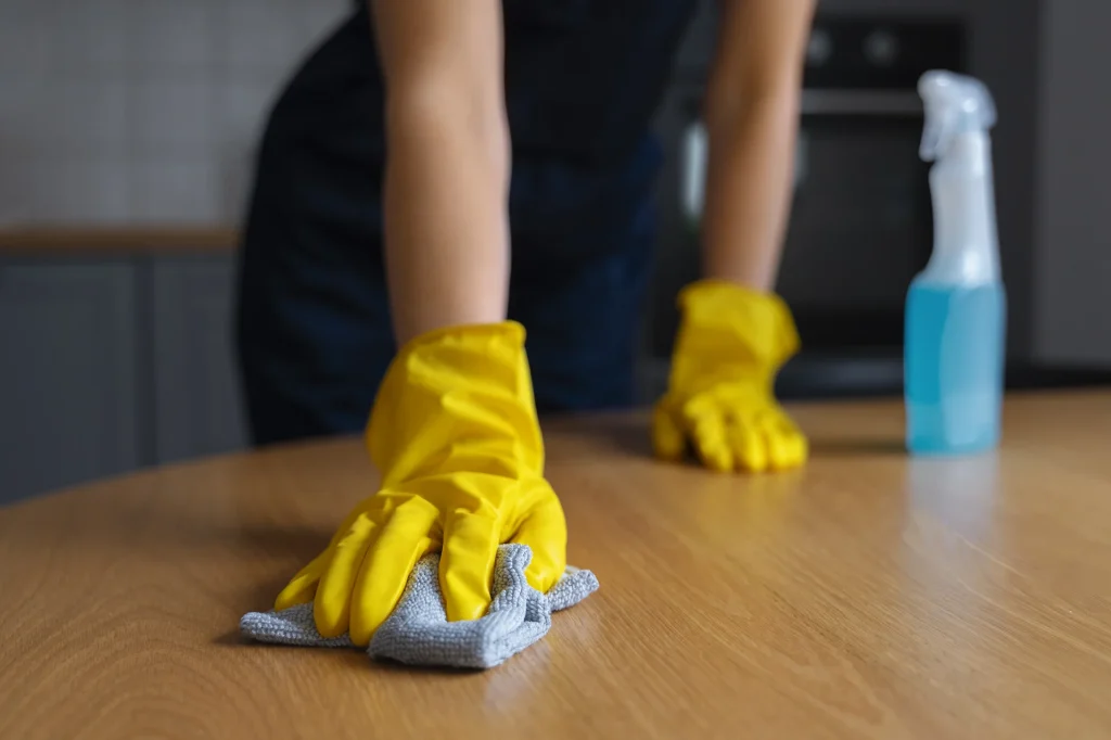 Woman Cleaning Wooden Table